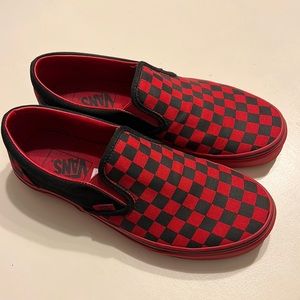 Red and black checked Vans slip-ons.
